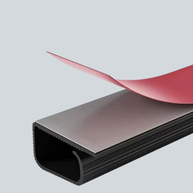 Doctor Desk self-adhesive black PVC cable management tray with a red peel-off backing for under-desk organization.
