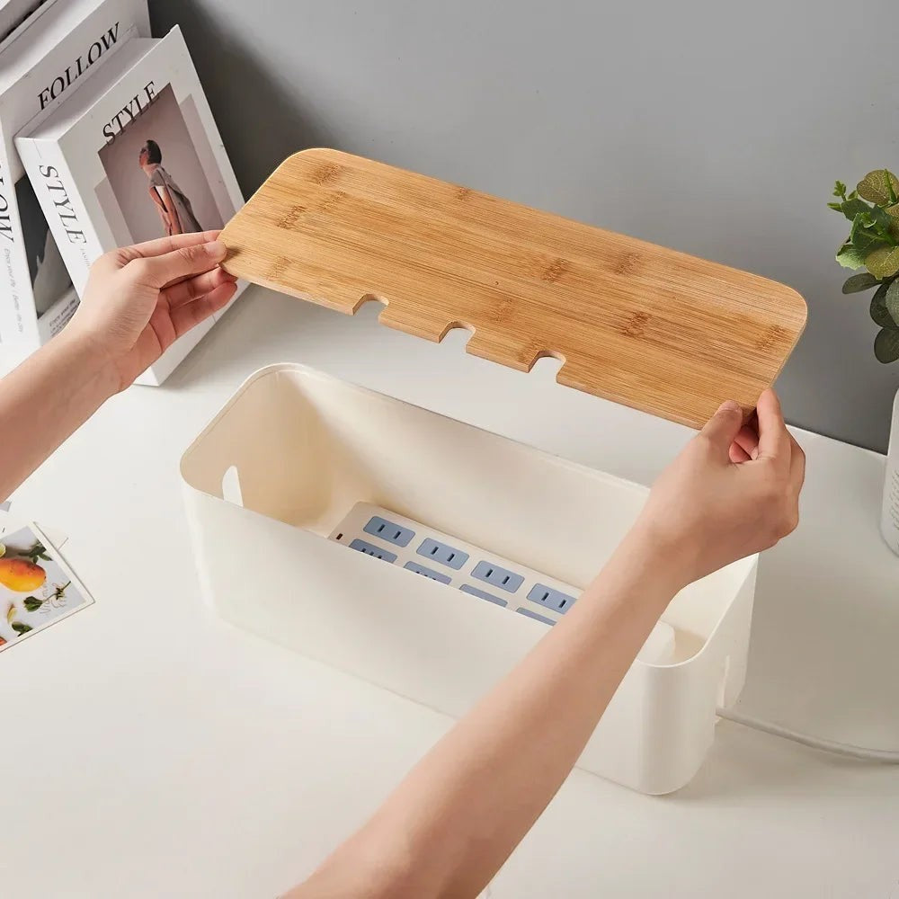 Doctor Desk bamboo and white cable management box with lid being placed over a power strip on a desk