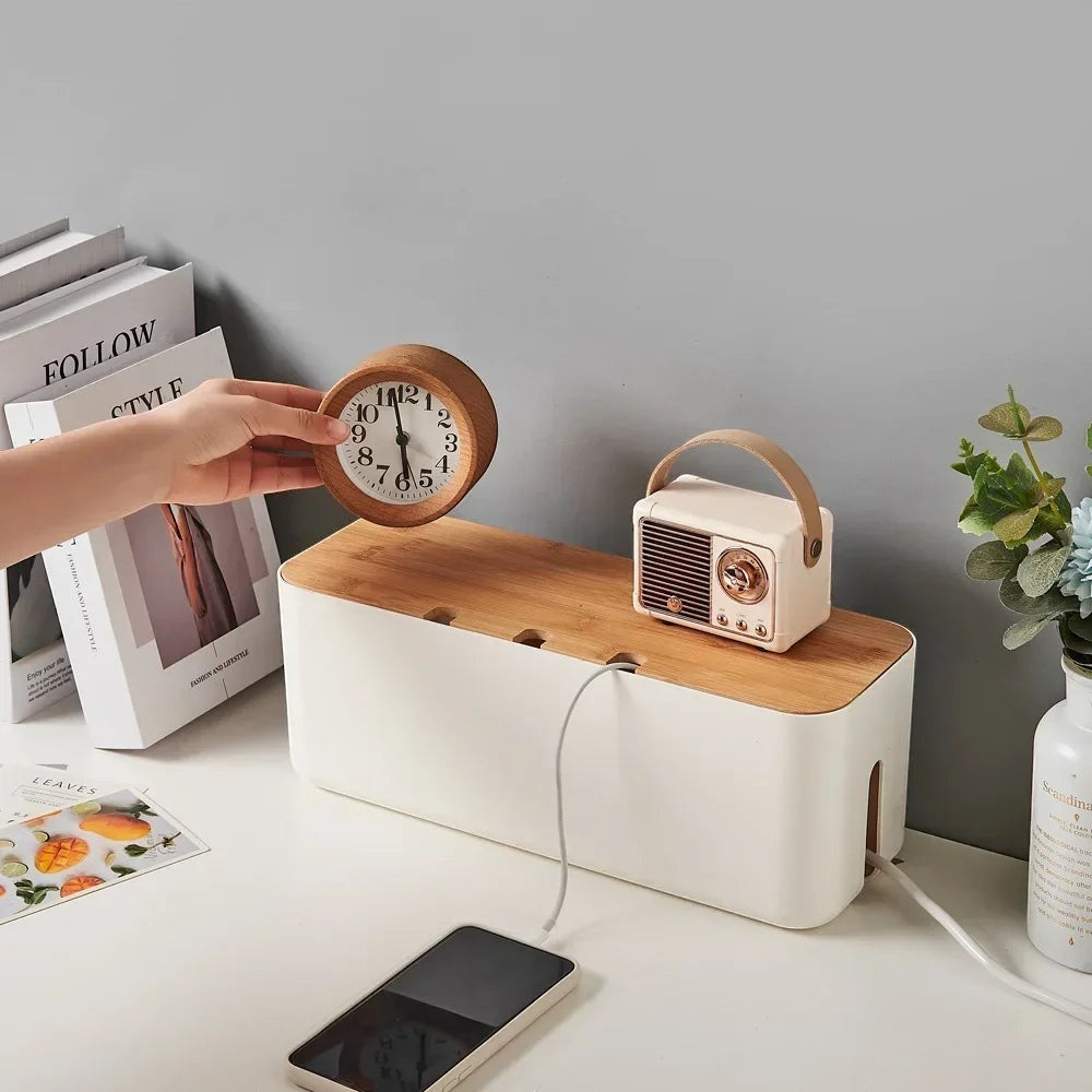 Doctor Desk bamboo cable management box with white base and wooden lid on a desk with a clock and radio