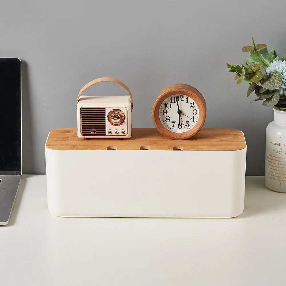 Doctor Desk bamboo cable management box with white base and wooden lid, holding a vintage radio and wooden clock.