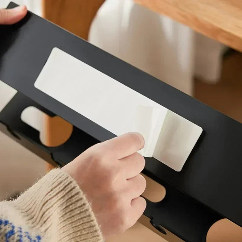 Doctor Desk black under desk cable tray with adhesive padding being applied for cable management