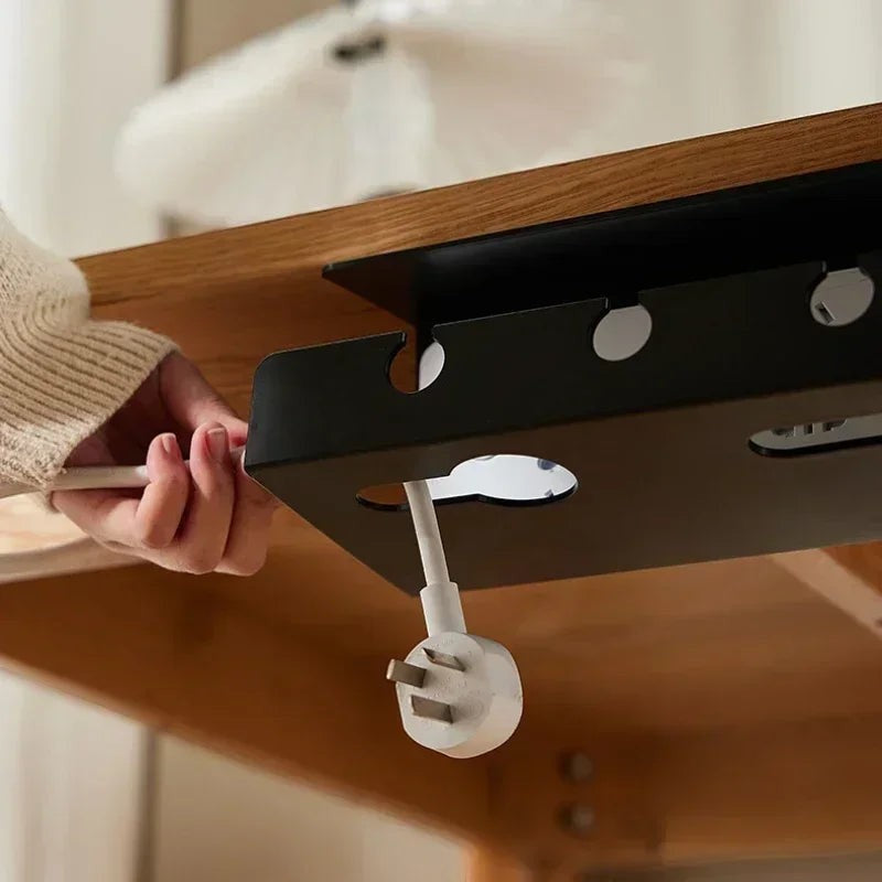 Doctor Desk black metal under desk cable tray with clamp mount attached to a wooden desk with a power cable