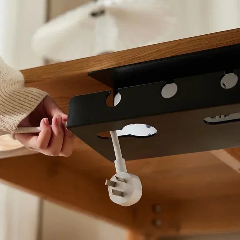 Doctor Desk black metal under desk cable tray with clamp mount being used to organize a power cord