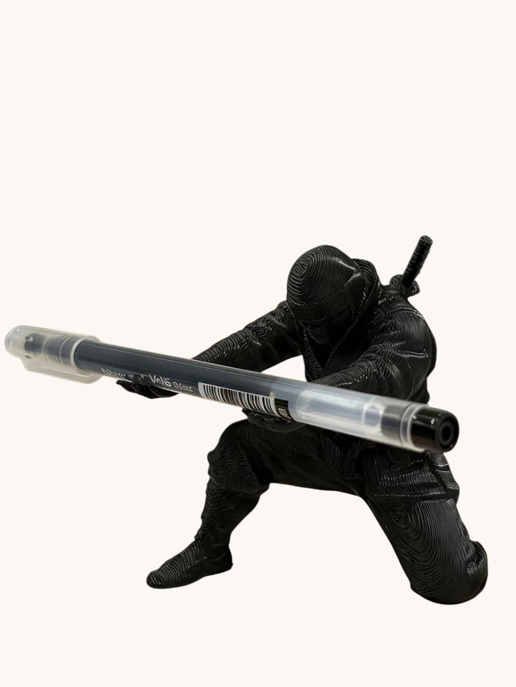 Doctor Desk 3D printed black ninja figurine pen holder in a dynamic crouching pose holding a pen on a desk