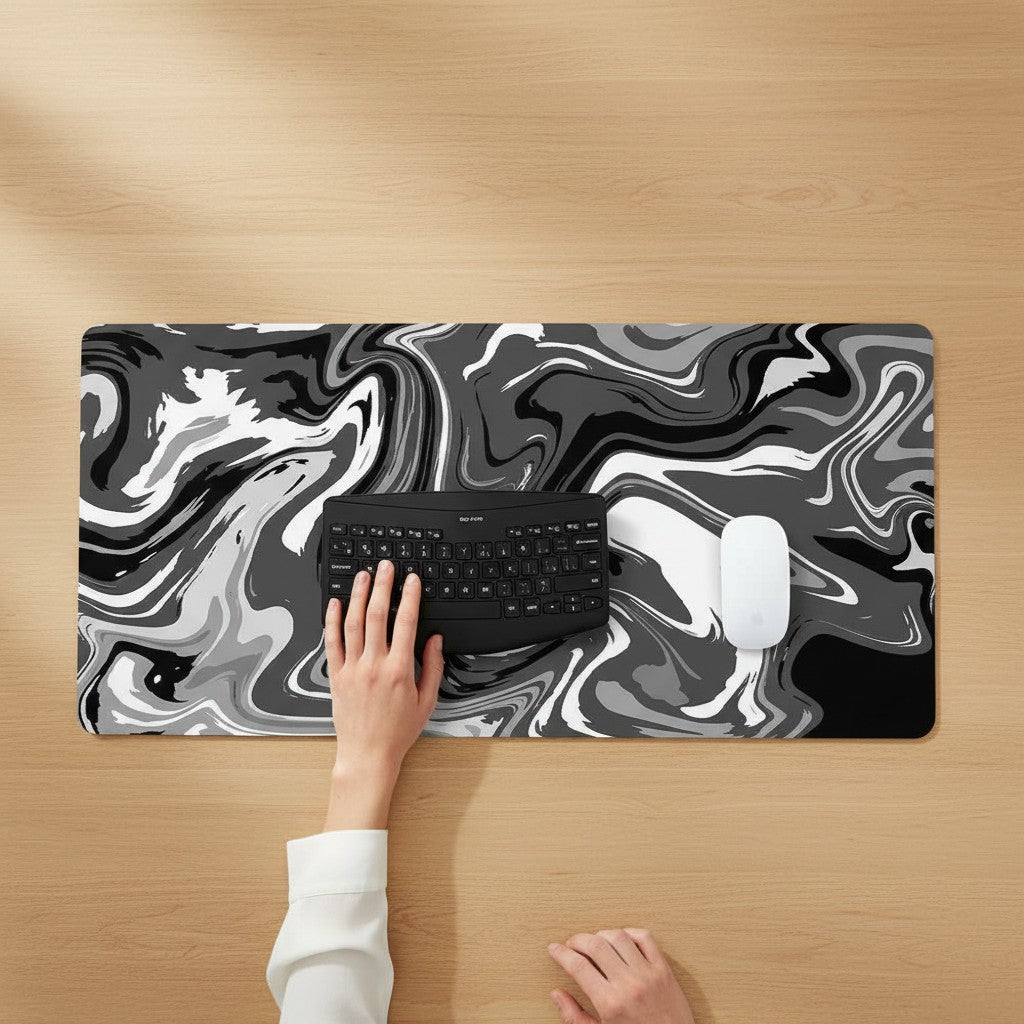Doctor Desk XXL desk mat with black and white liquid swirl pattern, featuring a non-slip rubber base and mouse.