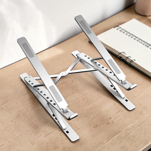 Doctor Desk foldable aluminium laptop stand with adjustable viewing angles on a wooden desk surface