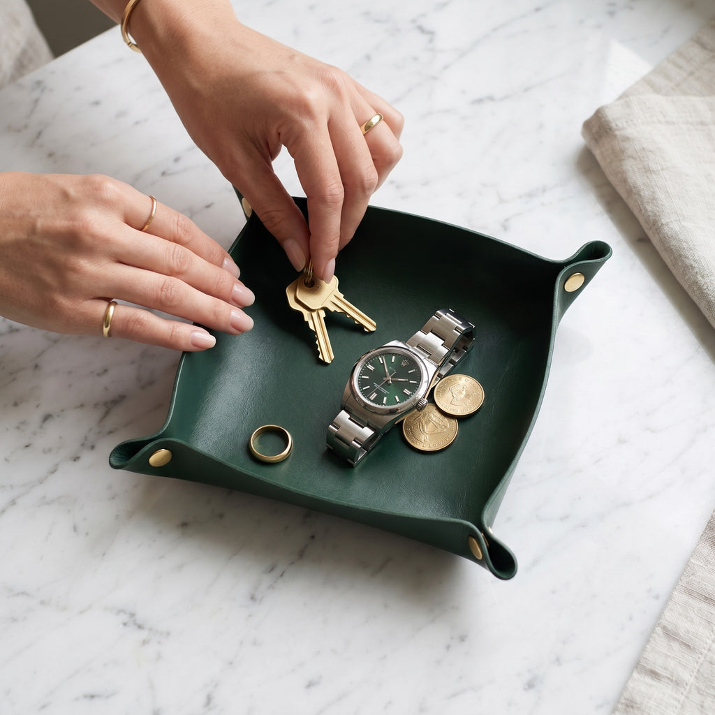 Doctor Desk dark green PU leather foldable valet tray holding a watch, keys, and coins on a marble surface