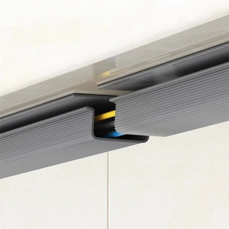 Doctor Desk self-adhesive grey PVC cable management tray mounted under a desk to organize power cords and cables.