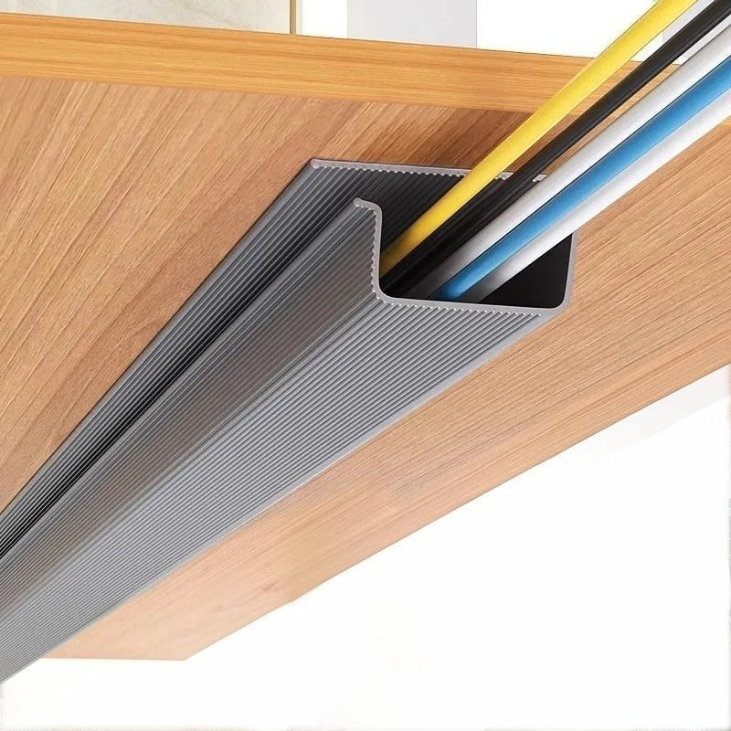 Doctor Desk self-adhesive grey PVC cable management tray mounted under a wooden desk with organized power cables.