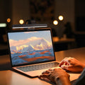Doctor Desk LED monitor light bar clipped to a laptop screen, providing glare-free illumination for the workspace.