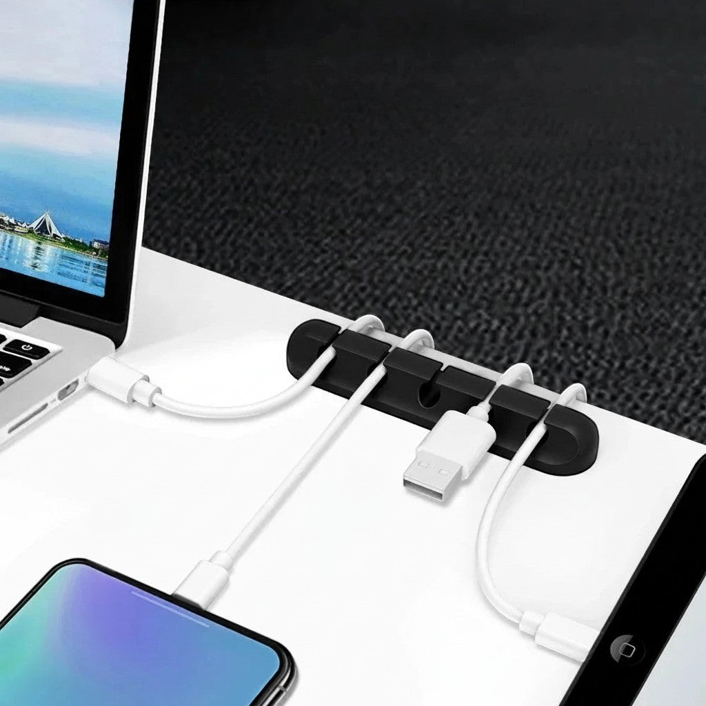 Doctor Desk grey silicone cable clips with multiple slots holding white charging cables on a white desk surface